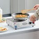 A stainless steel portable electric hot plate with a single burner and an 8-inch tubular element.