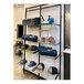 A black Udizine wall-mount retail clothing display with shelves holding hats.