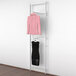 A white Udizine retail clothing display rack with white shelves and faceouts holding a pink dress and black shirt.