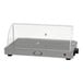 A silver and black Cadco countertop warming shelf with a roll top lid.