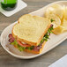 A sandwich on a plate with Martin's potato bread.