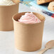 Two Choice paper food cups filled with ice cream on a white background.