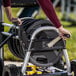 A person pushing a Gorilla heavy-duty hose reel cart with a hose on it.