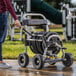 A woman using a Gorilla heavy-duty hose reel cart to hold a hose.