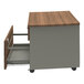 A Correll steel mobile pedestal filing cabinet with walnut laminate drawers on a wooden surface.