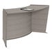 A Correll curved reception desk with a pen on it.