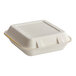 A white bagasse hinged takeout container with a yellow trim.