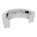 A white curved Correll reception desk with a computer and a monitor on it.