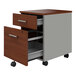 A Correll steel mobile pedestal filing cabinet with 2 cherry laminate drawers on wheels.