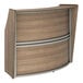 A Correll walnut laminate reception counter with a curved top.
