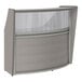 A grey Correll laminate reception desk with a curved front.