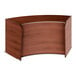 A cherry wood curved reception desk with a curved top.