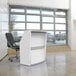 A white Correll reception desk with a curved panel.