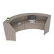 A Correll curved reception counter desk with a computer and keyboard on it.