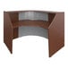 A brown and white curved reception desk with a see-through panel.