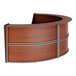 A cherry laminate Correll reception desk with a curved top.