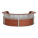 A Correll cherry laminate curved reception desk with a see-through top panel.