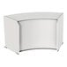 A white curved desk with a white door.