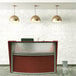 A Correll cherry laminate reception desk with a see-through top panel.