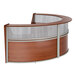 A cherry wood Correll curved reception desk with see-through top panels.