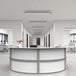 A white curved U-shaped reception counter with a white chair in a white office.