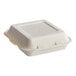 A Dart white bagasse hinged takeout container with 3 compartments.