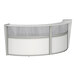 A white curved reception desk with a glass top.