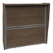 A brown and grey wood Correll reception desk with a sliding door and drawer.