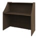 A brown Correll reception desk with a shelf on top.
