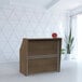A Correll walnut laminate reception desk with a wooden top.