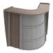 A walnut laminate curved reception desk with a curved top.