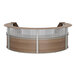 A Correll walnut laminate curved reception desk with glass panels.
