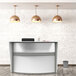 A white Correll single panel curved reception desk.