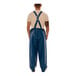 A man wearing blue Tingley Eclipse overalls with white tape accents.