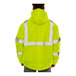 A person wearing a Tingley hi-vis lime pullover jacket with black panels.