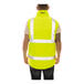 A back view of a man wearing a Tingley Hi-Vis yellow and black reversible insulated vest.