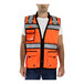 A man wearing a Tingley orange safety vest with reflective stripes.