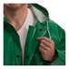 A man wearing a Tingley SafetyFlex green rain coat with a hood.