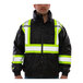 A man wearing a black Tingley Bomber II jacket with yellow and white reflective stripes.