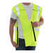 A man wearing a Tingley Hi-Vis yellow flame-resistant safety vest.