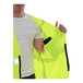 A man holding a Tingley Job Sight yellow safety vest.