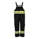 A pair of black Tingley overalls with reflective tape on the front.