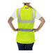 A woman wearing a Tingley hi-vis yellow mesh safety vest.