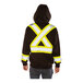 A person wearing a Tingley black zip-up sweatshirt with yellow X-back reflective tape and a detachable hood.