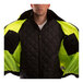 A man wearing a Tingley Bomber 3.1 Hi-Vis Lime jacket with black panels.