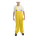 A man wearing a yellow Tingley rainsuit stands in front of a white background.