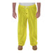 A person wearing yellow Tingley Eagle rainsuit pants.