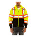 A man wearing a yellow Tingley hi-vis sweatshirt with reflective tape and a detachable hood.