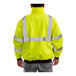 A person wearing a Tingley hi-vis lime yellow and black jacket.
