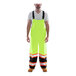 A man wearing Tingley hi-vis lime yellow overalls with black cuffs.